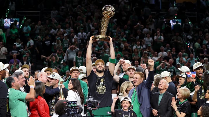 Jun 17, 2024; Boston, Massachusetts, USA; Boston Celtics forward Jayson Tatum (0) lifts the trophy after winning the 2024 NBA Finals against the Dallas Mavericks at TD Garden. Mandatory Credit: Peter Casey-USA TODAY Sports