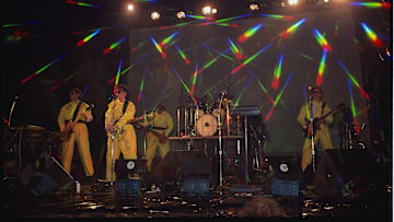 Devo Performing in Yellow Plastic Coveralls