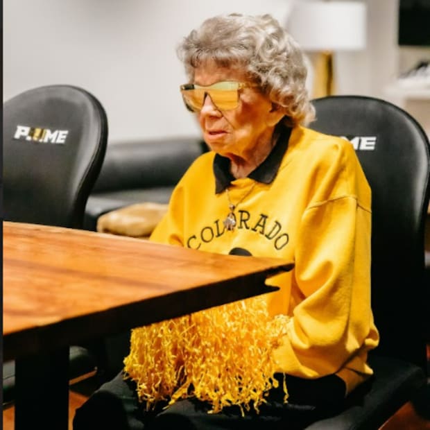 Colorado Buffaloes superfan posing in her Blenders Eyewear sunglasses.