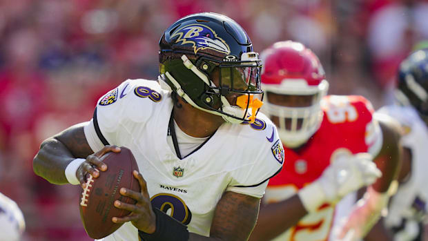 Baltimore Ravens quarterback Lamar Jackson (8) rolls out to pass during the first half against the Kansas City Chiefs.