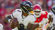 Baltimore Ravens quarterback Lamar Jackson (8) rolls out to pass