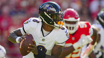 Baltimore Ravens quarterback Lamar Jackson (8) rolls out to pass