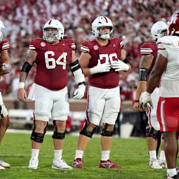 Oklahoma Sooners offensive linemen Jake Taylor (79), Febechi Nwaiwu (54), Joshua Bates (64), Jacob Sexton (76) and Michael Tarquin (far right).