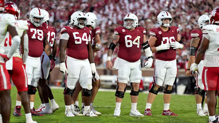 Oklahoma Sooners offensive linemen Jake Taylor (79), Febechi Nwaiwu (54), Joshua Bates (64), Jacob Sexton (76) and Michael Tarquin (far right).