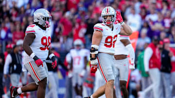 Ohio State Buckeyes defensive end Caden Curry (92) celebrates a sack of Washington Huskies quarterback Demond Williams Jr. (2) during the second half of the NCAA football game at Husky Stadium in Seattle on Sept. 27, 2025. Ohio State won 24-6.