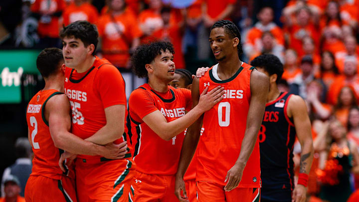 Feb 21, 2026; Fort Collins, Colorado, USA; Colorado State Rams guard Jase Butler (4) reacts with forward Carey Booth (0) as forward Kyle Jorgensen (35) and guard Brandon Rechsteiner (2) walk to center court in the first half against the San Diego State Aztecs at Moby Arena.