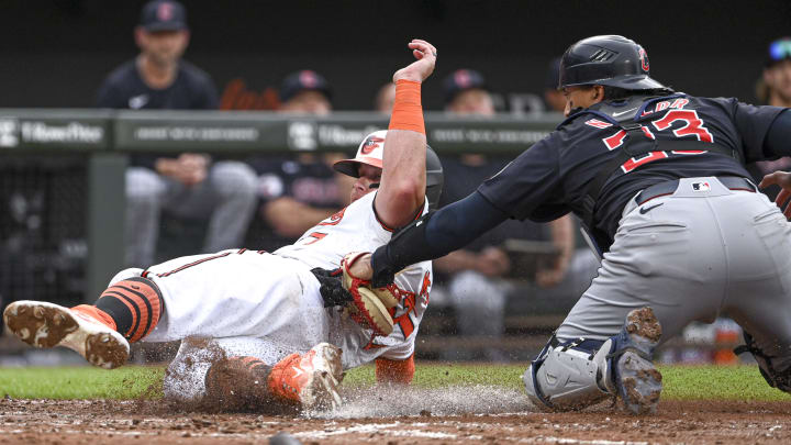 Jun 25, 2024; Baltimore, Maryland, USA;  Cleveland Guardians catcher Bo Naylor (23) tags a sliding Baltimore Orioles catcher James McCann (27) out at the plate during the second inning at Oriole Park at Camden Yards. Mandatory Credit: Tommy Gilligan-USA TODAY Sports