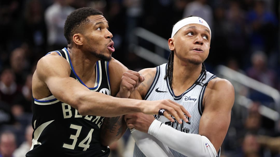 Jan 10, 2025; Orlando, Florida, USA; Milwaukee Bucks forward Giannis Antetokounmpo (34) guards Orlando Magic forward Paolo Banchero (5) in the fourth quarter at Kia Center. Mandatory Credit: Nathan Ray Seebeck-Imagn Images