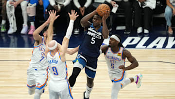 May 26, 2025; Minneapolis, Minnesota, USA; Minnesota Timberwolves guard Anthony Edwards (5) attempts to make a pass against Oklahoma City Thunder guard Alex Caruso (9), guard Luguentz Dort (5) and forward Chet Holmgren (7) in the first half during game four of the western conference finals for the 2025 NBA Playoffs at Target Center. Mandatory Credit: Jesse Johnson-Imagn Images