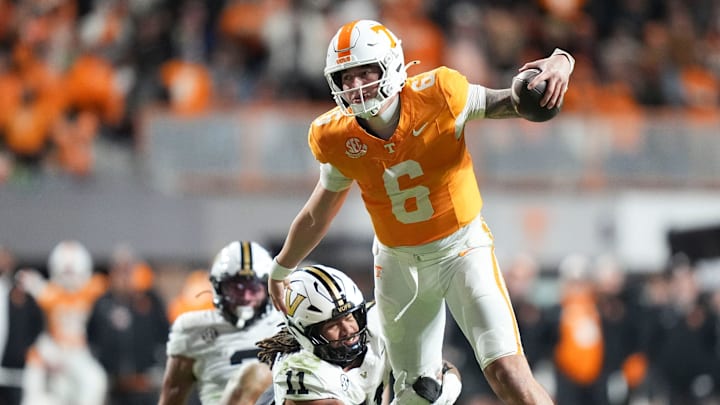 Tennessee quarterback Joey Aguilar (6) tries to get away from Vanderbilt linebacker Bryan Longwell (11) during an NCAA college football game on Nov. 29, 2025, in Knoxville, Tennessee.