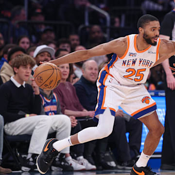 Apr 6, 2025; New York, New York, USA; New York Knicks forward Mikal Bridges (25) is guarded by Phoenix Suns guard Devin Booker (1) during the first half at Madison Square Garden. Mandatory Credit: Vincent Carchietta-Imagn Images