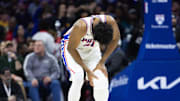 Feb 22, 2025; Philadelphia, Pennsylvania, USA; Philadelphia 76ers center Joel Embiid (21) holds his leg after a play against the Brooklyn Nets during the second quarter at Wells Fargo Center. Mandatory Credit: Bill Streicher-Imagn Images