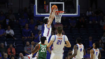 Nov 19, 2024; Gainesville, Florida, USA; Florida Gators guard Walter Clayton Jr. (1) dunks a ball over Florida A&M Rattlers forward Jamine Charles (20) during the first half at Exactech Arena at the Stephen C. O'Connell Center. Mandatory Credit: Morgan Tencza-Imagn Images