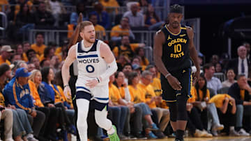 May 12, 2025; San Francisco, California, USA; Minnesota Timberwolves guard Donte DiVincenzo (0) reacts next to Golden State Warriors forward Jimmy Butler III (10) after making a three point basket in the third quarter during game four of the second round for the 2025 NBA Playoffs at Chase Center. Mandatory Credit: Cary Edmondson-Imagn Images