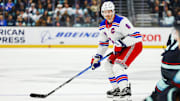 Nov 17, 2024; Seattle, Washington, USA; New York Rangers defenseman Jacob Trouba (8) looks to pass against the Seattle Kraken during the second period at Climate Pledge Arena. Mandatory Credit: Joe Nicholson-Imagn Images