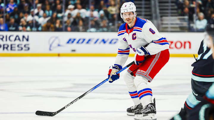 Nov 17, 2024; Seattle, Washington, USA; New York Rangers defenseman Jacob Trouba (8) looks to pass against the Seattle Kraken during the second period at Climate Pledge Arena. Mandatory Credit: Joe Nicholson-Imagn Images