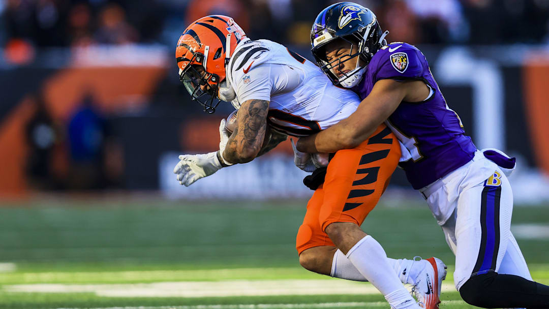 Dec 14, 2025; Cincinnati, Ohio, USA; Baltimore Ravens safety Kyle Hamilton (14) brings down Cincinnati Bengals running back Chase Brown (30) in the second half at Paycor Stadium. Mandatory Credit: Katie Stratman-Imagn Images