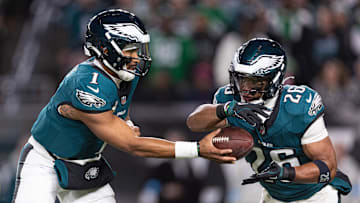 Nov 14, 2024; Philadelphia, Pennsylvania, USA; Philadelphia Eagles quarterback Jalen Hurts (1) hands off to running back Saquon Barkley (26) during the first quarter against the Washington Commanders at Lincoln Financial Field. Mandatory Credit: Bill Streicher-Imagn Images