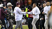 Nov 30, 2024; College Station, Texas, USA; Texas A&M Aggies head coach Mike Elko, left, shakes hands with Texas Longhorns head coach Steve Sarkisian after the game. The Longhorns defeated the Aggies 17-7. at Kyle Field. Mandatory Credit: Maria Lysaker-Imagn Images 