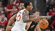 Feb 8, 2025; Louisville, Kentucky, USA;  Louisville Cardinals center Frank Anselem-Ibe (13) pressures the dribble of Miami (Fl) Hurricanes guard Matthew Cleveland (0) during the second half at KFC Yum! Center. Louisville defeated Miami 88-78. Mandatory Credit: Jamie Rhodes-Imagn Images