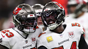 Oct 26, 2025; New Orleans, Louisiana, USA; Tampa Bay Buccaneers outside linebacker Lavonte David (54) and safety Tykee Smith (23) react after a tackle during the first quarter against the New Orleans Saints at Caesars Superdome. Mandatory Credit: Stephen Lew-Imagn Images