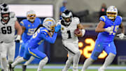 Dec 8, 2025; Inglewood, California, USA; Philadelphia Eagles quarterback Jalen Hurts (1) runs against Los Angeles Chargers cornerback Donte Jackson (26) in overtime at SoFi Stadium. 