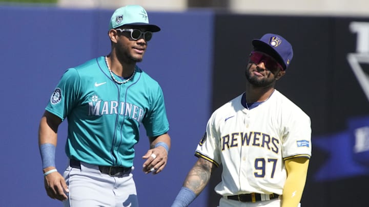 Mar 9, 2024; Phoenix, Arizona, USA; Seattle Mariners center fielder Julio Rodriguez (44) and Milwaukee Brewers right fielder Hedbert Perez (97) joke around before a game at American Family Fields of Phoenix. Mandatory Credit: Rick Scuteri-Imagn Images