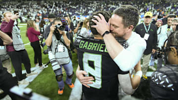 Oregon Ducks head coach Dan Lanning hugs quarterback Dillon Gabriel (8) 