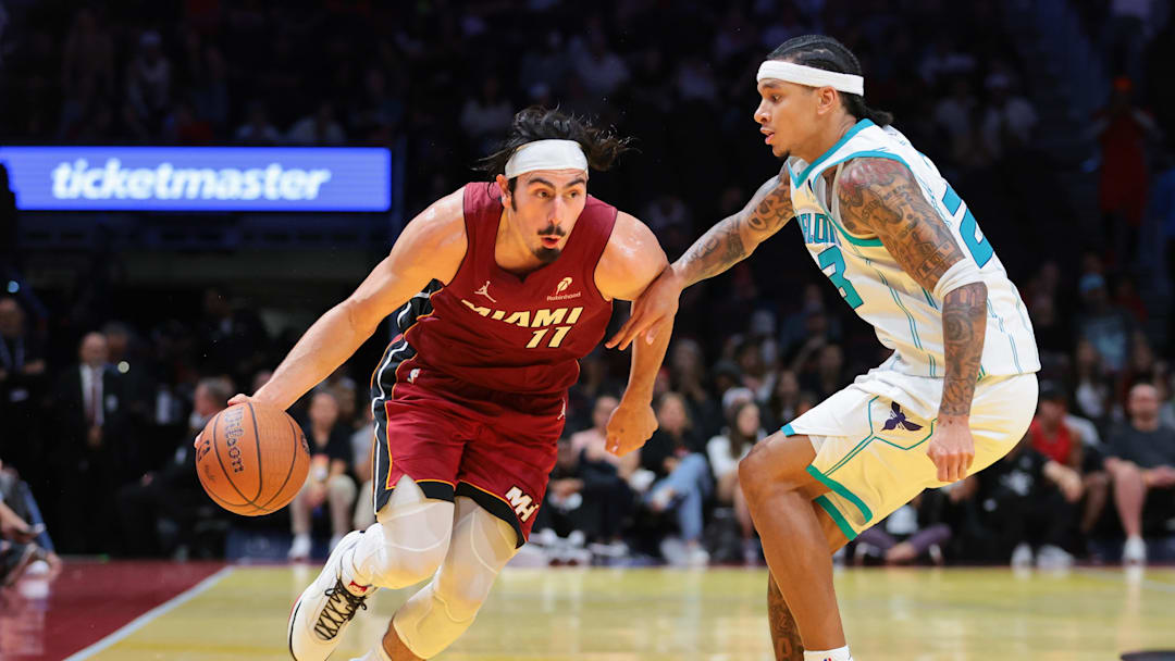 Nov 7, 2025; Miami, Florida, USA; Miami Heat forward Jaime Jaquez Jr. (11) drives to the basket against Charlotte Hornets guard Tre Mann (23) during the fourth quarter of an NBA Cup game at Kaseya Center. Mandatory Credit: Sam Navarro-Imagn Images