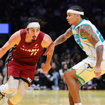 Nov 7, 2025; Miami, Florida, USA; Miami Heat forward Jaime Jaquez Jr. (11) drives to the basket against Charlotte Hornets guard Tre Mann (23) during the fourth quarter of an NBA Cup game at Kaseya Center. Mandatory Credit: Sam Navarro-Imagn Images