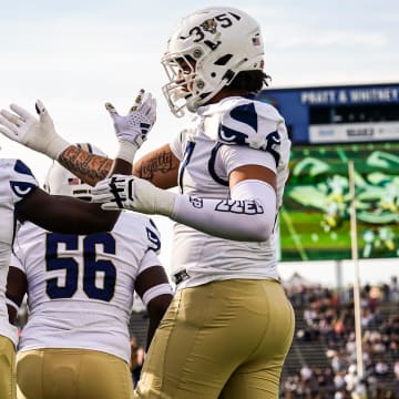 Sep 16, 2023; East Hartford, Connecticut, USA; FIU Golden Panthers wide receiver Jalen Bracey (14) is congratulated after making a touchdown against the UConn Huskies in the second quarter at Rentschler Field at Pratt & Whitney Stadium. Mandatory Credit: David Butler II-USA TODAY Sports