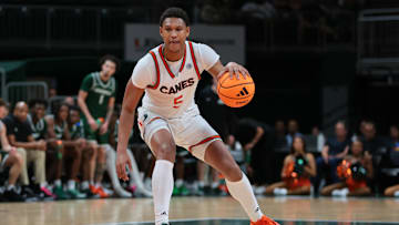 Nov 3, 2025; Coral Gables, Florida, USA; Miami Hurricanes forward Malik Reneau (5) dribbles the basketball against the Jacksonville Dolphins during the second half at Watsco Center. Mandatory Credit: Sam Navarro-Imagn Images