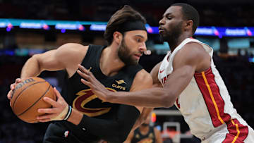 Apr 26, 2025; Miami, Florida, USA; Cleveland Cavaliers guard Max Strus (1) protects the basketball from Miami Heat forward Andrew Wiggins (22) in the first quarter during game three for the first round of the 2025 NBA Playoffs at Kaseya Center. Mandatory Credit: Sam Navarro-Imagn Images