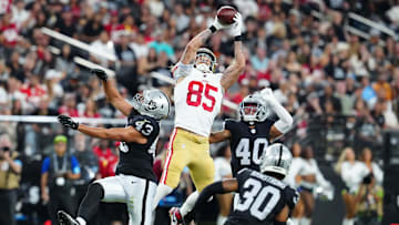 Aug 23, 2024; Paradise, Nevada, USA; San Francisco 49ers tight end George Kittle (85) makes a catch between Las Vegas Raiders linebacker Kana'i Mauga (43) and Las Vegas Raiders safety Jaydon Grant (40) during the first quarter at Allegiant Stadium. Mandatory Credit: Stephen R. Sylvanie-Imagn Images