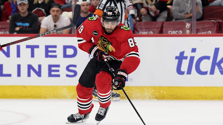 Apr 14, 2024; Chicago, Illinois, USA;  Chicago Blackhawks forward Andreas Athanasiou (89) skates against the Carolina Hurricanes at United Center. Mandatory Credit: Jamie Sabau-Imagn Images