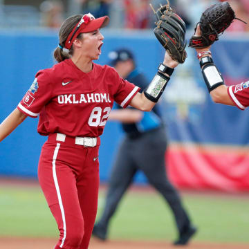 Oklahoma's Avery Hodge (82) celebrates a double play with pitcher Karlie Keeney (8) in the first inning of Game 2 of the NCAA softball Women's College World Series Championship Series game between the Oklahoma Sooners (OU) and Texas Longhorns at Devon Park in Oklahoma City, Thursday, June, 6, 2024.