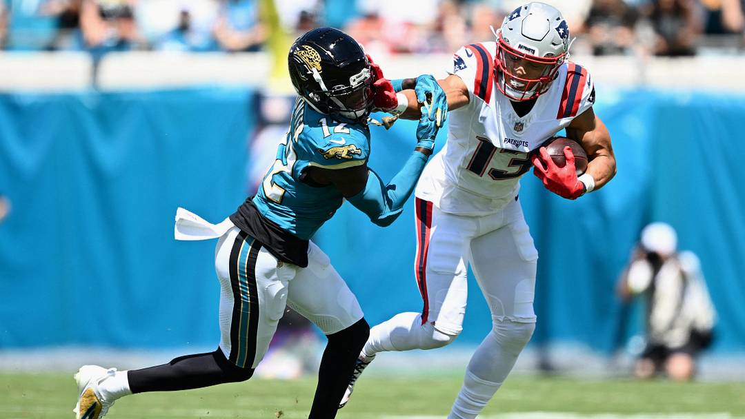 Sep 27, 2026; Jacksonville, Florida, USA; New England Patriots wide receiver Mack Hollins (13) runs for a gain past Jacksonville Jaguars wide receiver Travis Hunter (12) during the first quarter at EverBank Stadium. Mandatory Credit: Melina Myers-Imagn Images Sep 27, 2026; Jacksonville, Florida, USA; New England Patriots wide receiver Mack Hollins (13) runs for a gain past Jacksonville Jaguars wide receiver Travis Hunter (12) during the first quarter at EverBank Stadium. Mandatory Credit: Melina Myers-Imagn Images