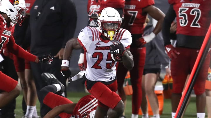 Louisville’s Isaac Brown runs against Louisville’s defense Friday night at L&N Stadium