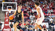 Jan 21, 2025; Tuscaloosa, Alabama, USA; Vanderbilt Commodores guard Grant Huffman (4) drives the ball against Alabama Crimson Tide guard Mark Sears (1) during the second half at Coleman Coliseum.