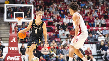 Jan 21, 2025; Tuscaloosa, Alabama, USA; Vanderbilt Commodores guard Grant Huffman (4) drives the ball against Alabama Crimson Tide guard Mark Sears (1) during the second half at Coleman Coliseum.