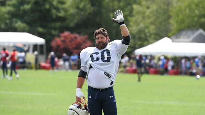 Aug 03, 2024; Foxborough, MA, USA; New England Patriots center David Andrews (60) waves to his son at training camp at Gillette Stadium. Mandatory Credit: Eric Canha-Imagn Images
