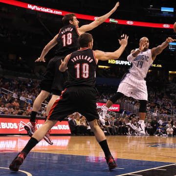 February 10, 2013; Orlando FL, USA; Orlando Magic point guard Jameer Nelson (14) passes the ball past Portland Trail Blazers small forward Victor Claver (18) during the second half at Amway Center. Orlando Magic defeated the Portland Trail Blazers 110-104. Mandatory Credit: Kim Klement-USA TODAY Sports