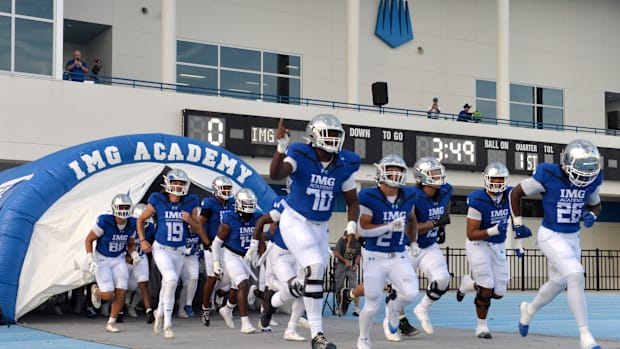 IMG Academy players run onto the field. The IMG Academy National squad hosted the Cocoa High School Tigers Friday, Sept. 6, 2
