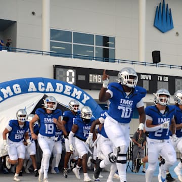 IMG Academy players run onto the field. The IMG Academy National squad hosted the Cocoa High School Tigers Friday, Sept. 6, 2024 in Bradenton.