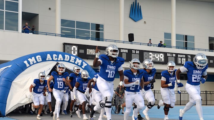 IMG Academy players run onto the field. The IMG Academy National squad hosted the Cocoa High School Tigers Friday, Sept. 6, 2024 in Bradenton.