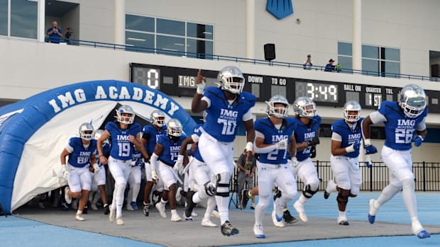 IMG Academy players run onto the field. The IMG Academy National squad hosted the Cocoa High School Tigers Friday, Sept. 6, 2
