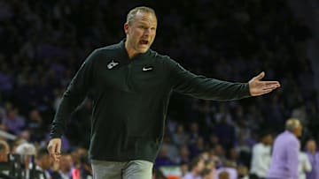 Jan 25, 2025; Manhattan, Kansas, USA; West Virginia Mountaineers head coach Darian DeVries questions a call by officials during the second half against the Kansas State Wildcats at Bramlage Coliseum. Mandatory Credit: Scott Sewell-Imagn Images