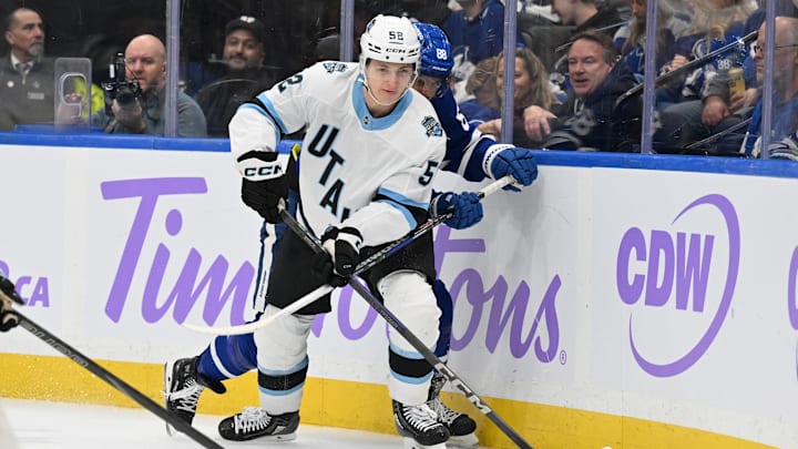 Nov 24, 2024; Toronto, Ontario, CAN;   Utah Hockey Club defenseman Vladislav Kolyachonok (52) controls the puck against Toronto Maple Leafs forward William Nylander (88) in the third period at Scotiabank Arena. Mandatory Credit: Dan Hamilton-Imagn Images