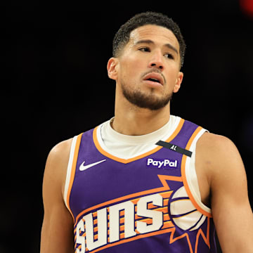 Apr 8, 2025; Phoenix, Arizona, USA; Phoenix Suns guard Devin Booker (1) reacts against the Golden State Warriors during the second half at Footprint Center. Mandatory Credit: Mark J. Rebilas-Imagn Images