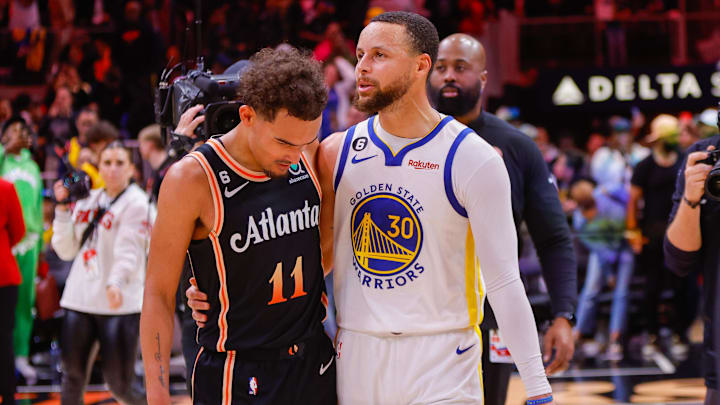 Mar 17, 2023; Atlanta, Georgia, USA; Atlanta Hawks guard Trae Young (11) talks to Golden State Warriors guard Stephen Curry (30) after a game at State Farm Arena. Mandatory Credit: Brett Davis-Imagn Images